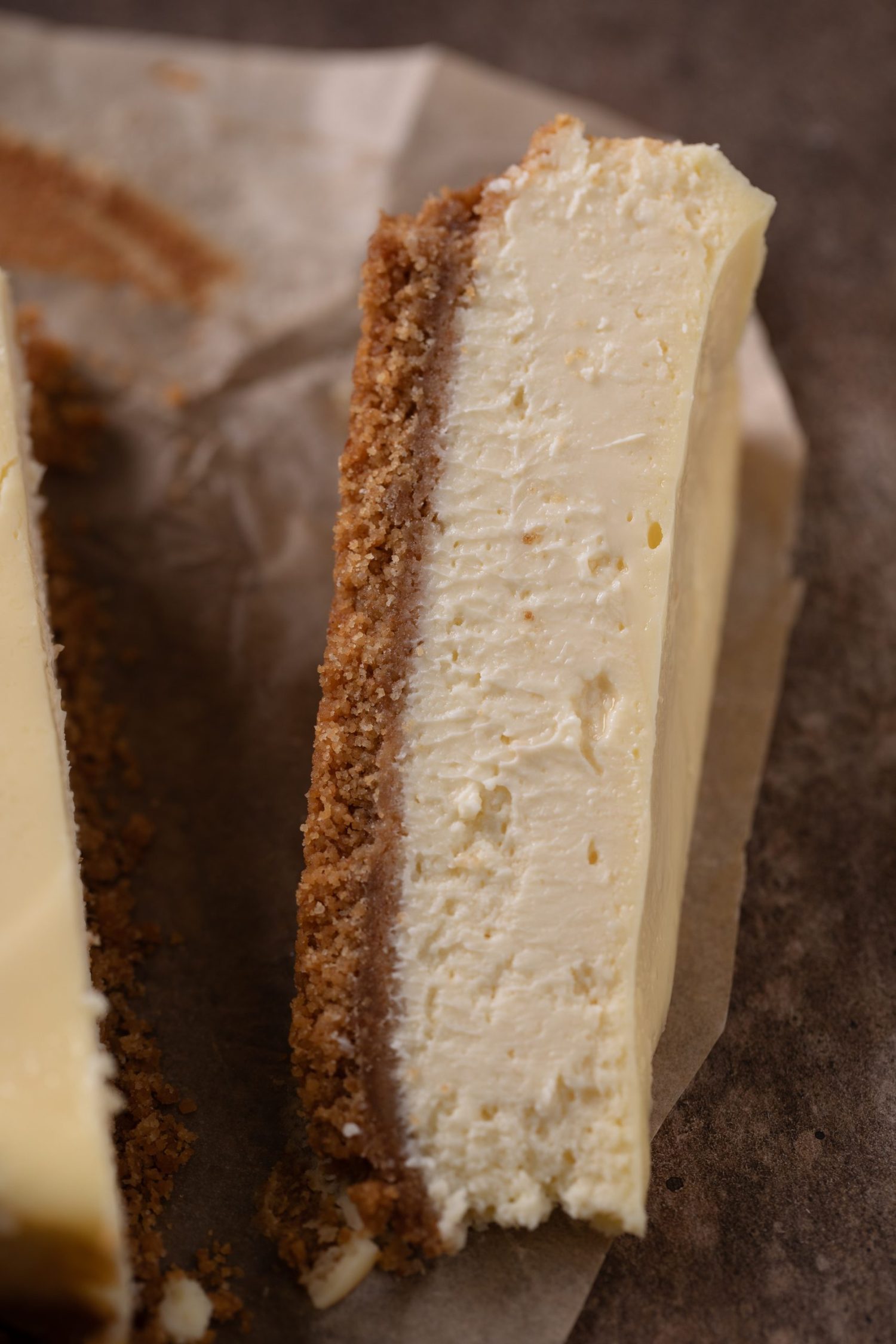 A texture shot of a slice of my loaf pan cheesecake; so creamy & delicious. | beatbakeeat.com