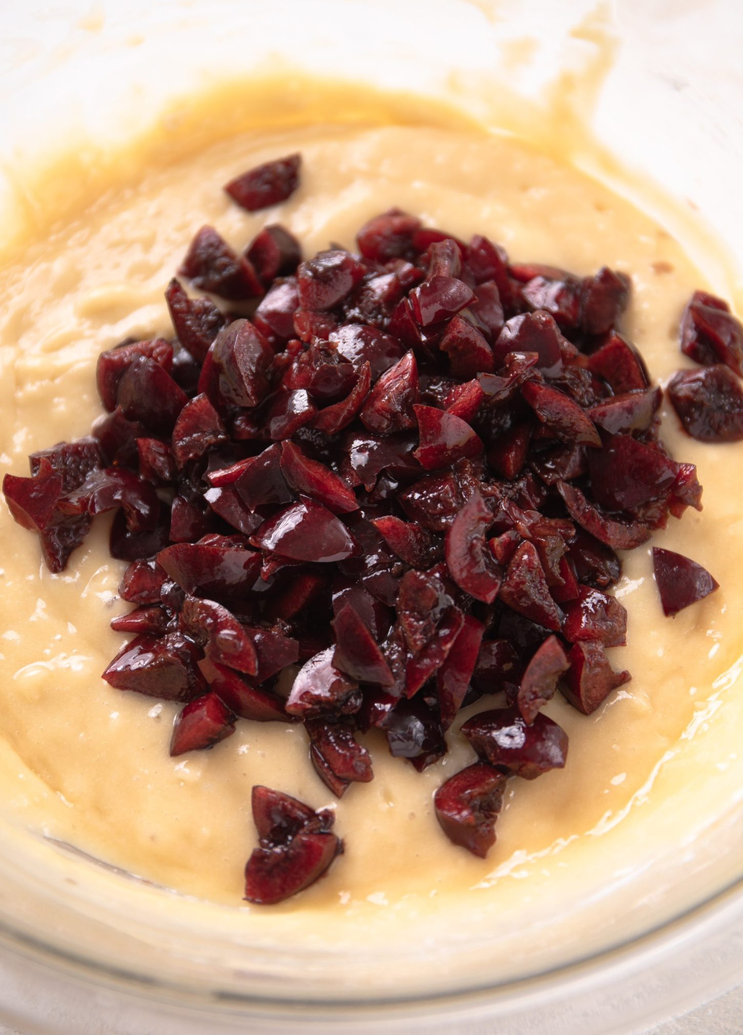 Chopped cherries in muffin batter.