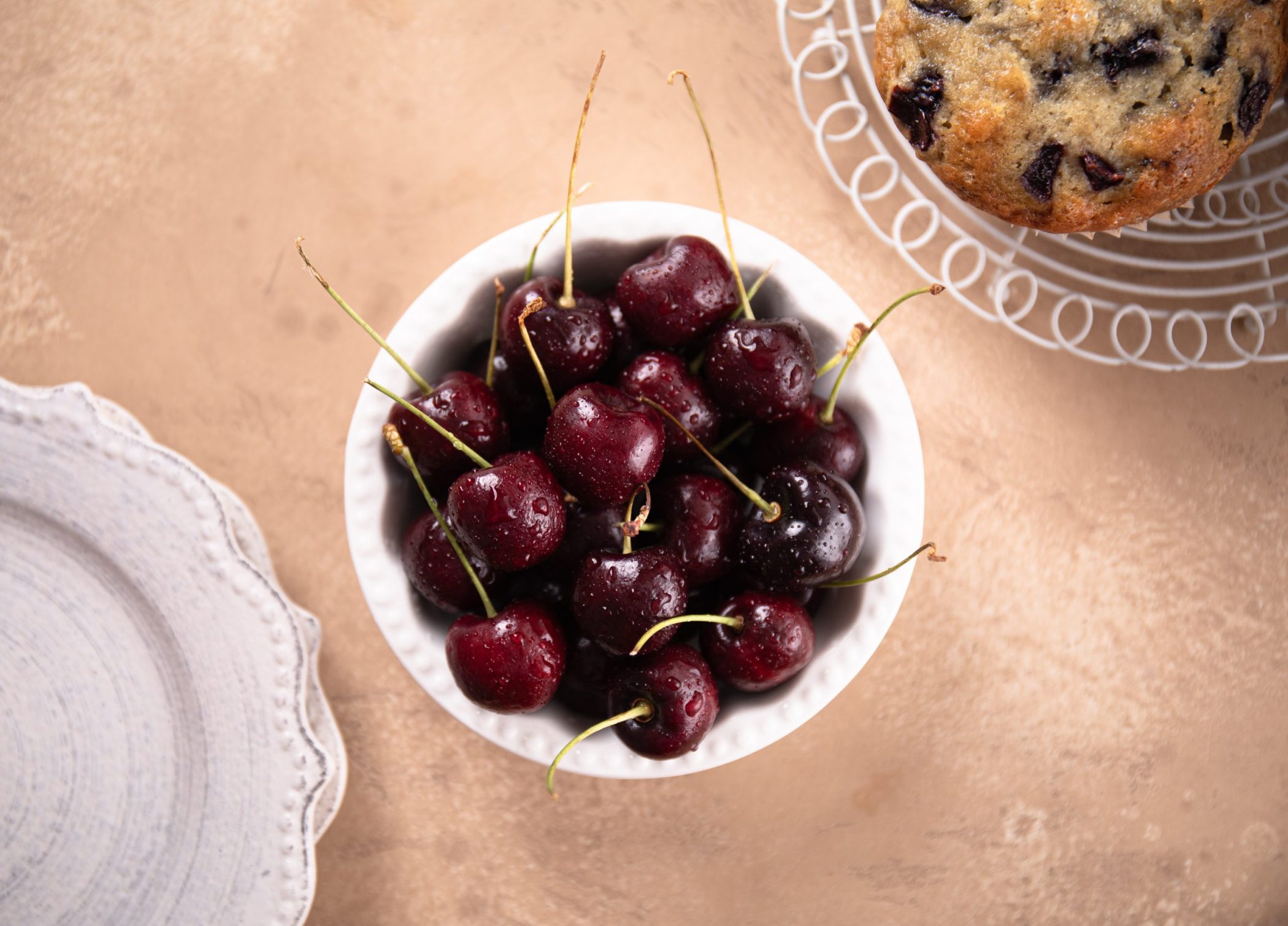 Ripe bing cherries in a small white bowl. | Food photography