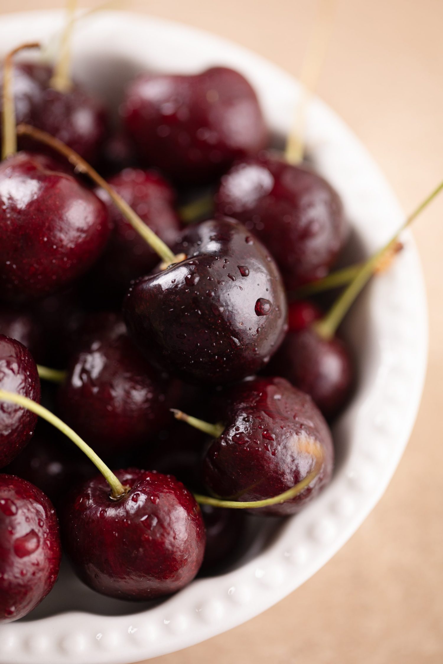 Juicy ripe bing cherries in a white bowl. | Food Photography